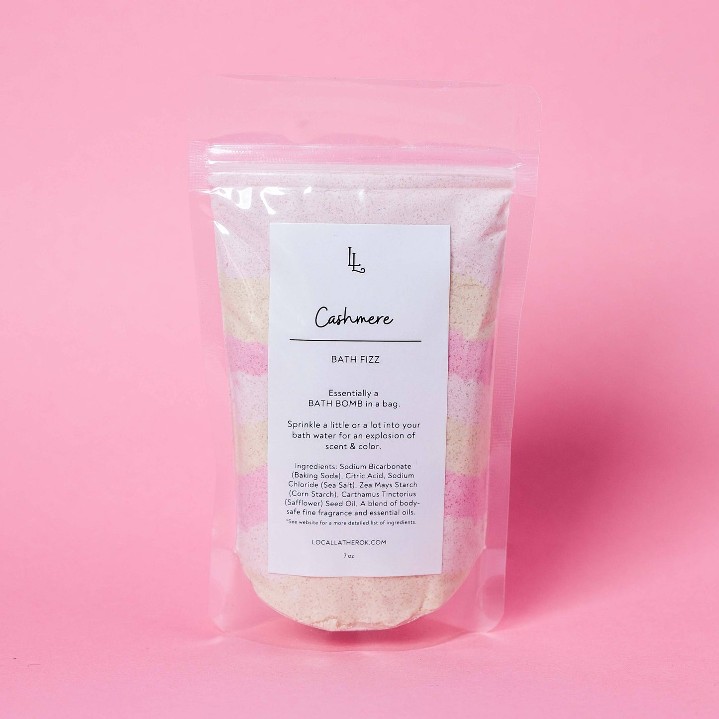 Bath fizz package labeled 'Cashmere' on a pink background