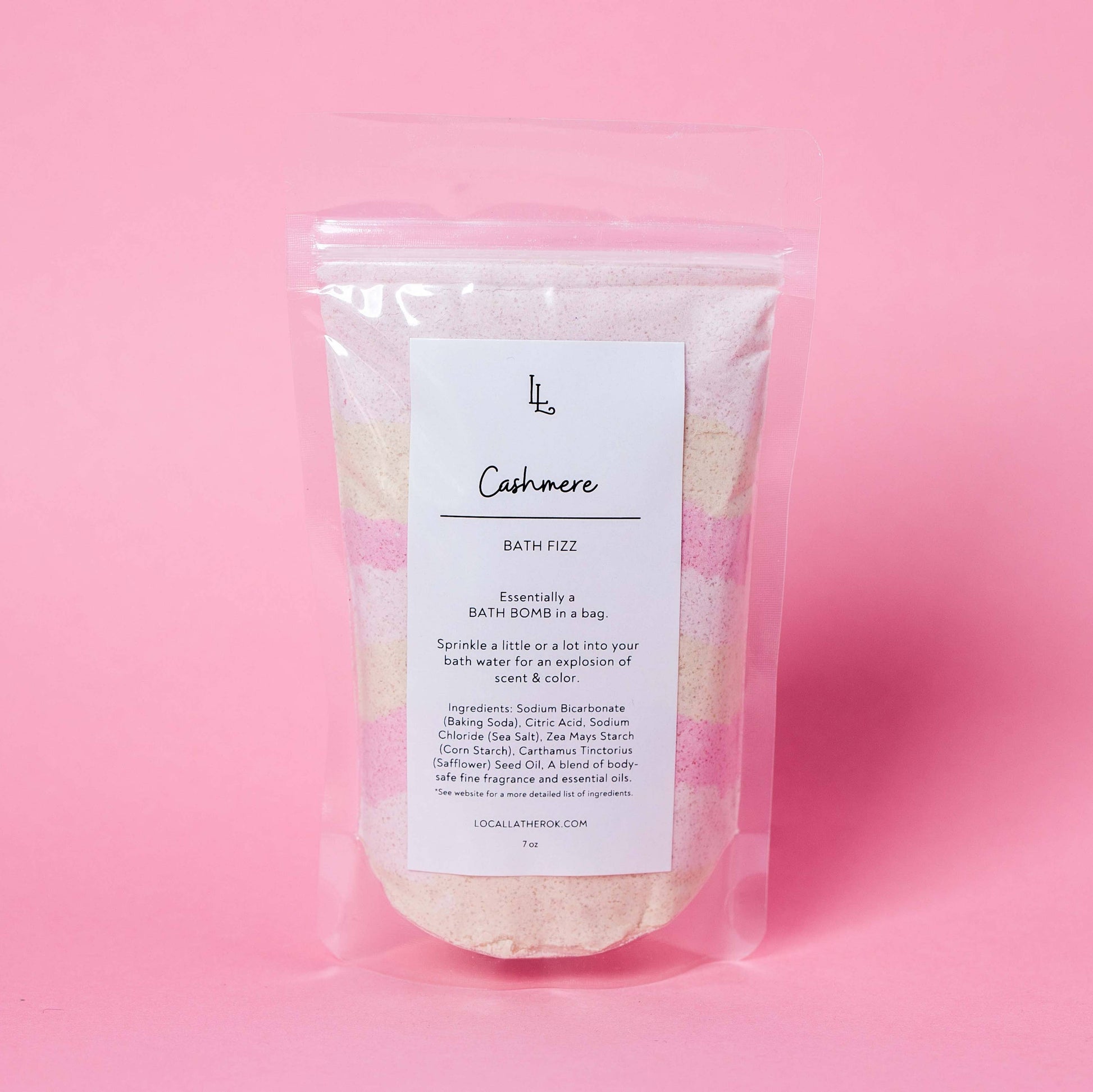 Bath fizz package labeled 'Cashmere' on a pink background