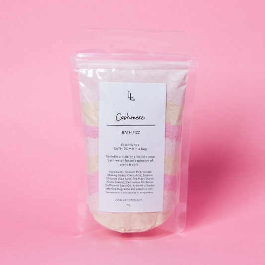 Bath fizz package labeled 'Cashmere' on a pink background