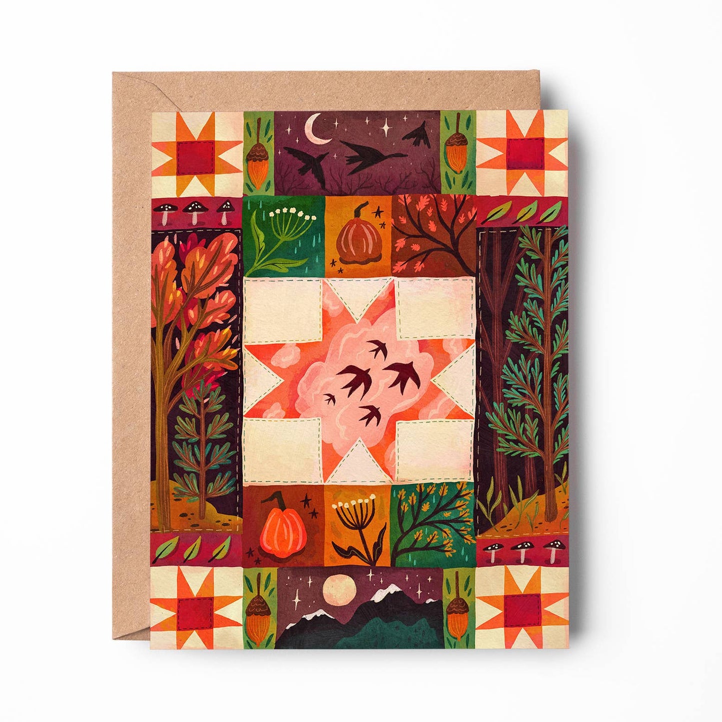 An autumn-themed art print card featuring a colorful quilted patchwork design with pumpkins, trees, stars, and birds, shown with a kraft envelope on a white background.