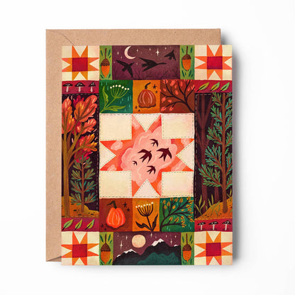 An autumn-themed art print card featuring a colorful quilted patchwork design with pumpkins, trees, stars, and birds, shown with a kraft envelope on a white background.