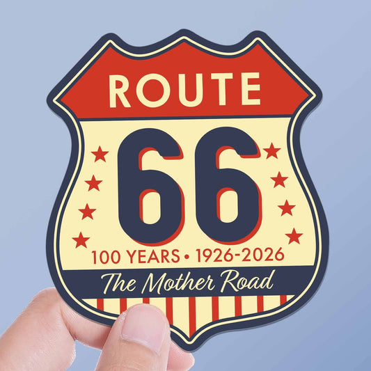 Sticker with Route 66 design held by a hand against a light blue background