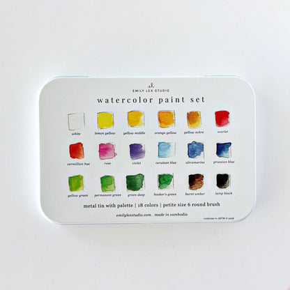 A metal tin watercolor paint set by Emily Lee Studio, showing 18 color wells with labeled watercolor swatches on a white background.