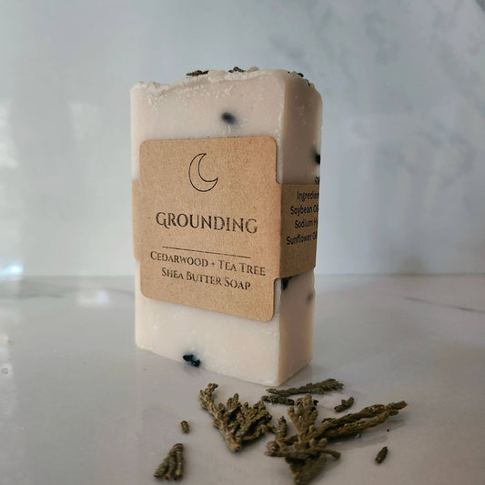 Bar of soap with a 'Grounding' label on a marble surface