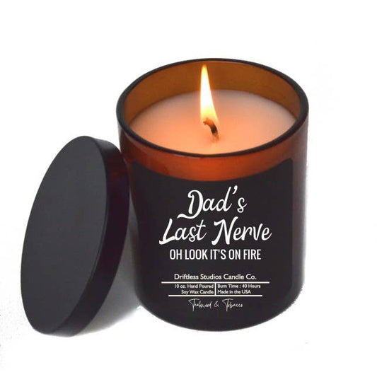 Candle in a black container with 'Dad's Last Nerve' text on a white background