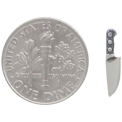 Silver U.S. dime coin with a knife on a white background