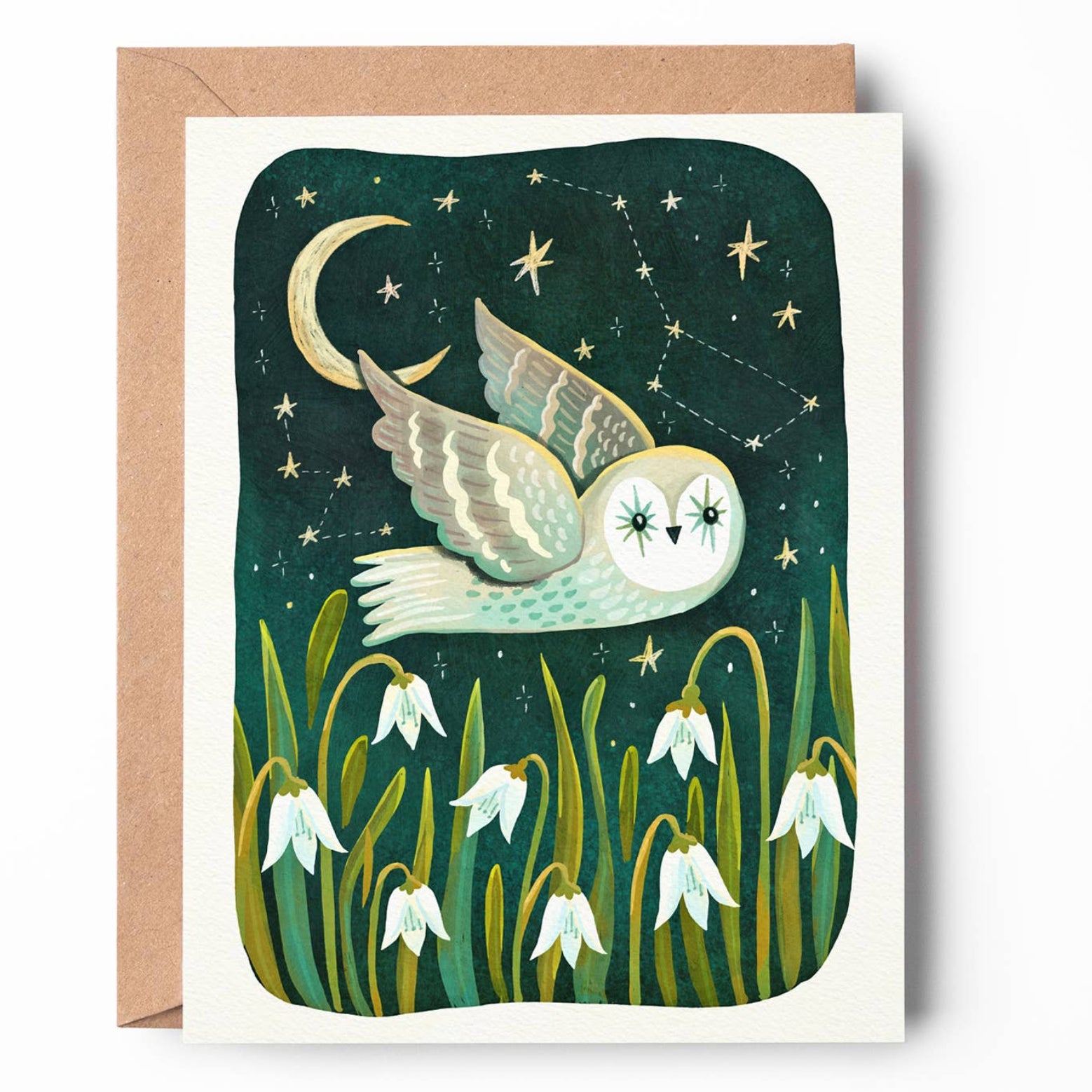 A square greeting card with a kraft envelope, featuring an illustration of a white owl flying at night under a crescent moon and stars, with snowdrop flowers at the bottom.