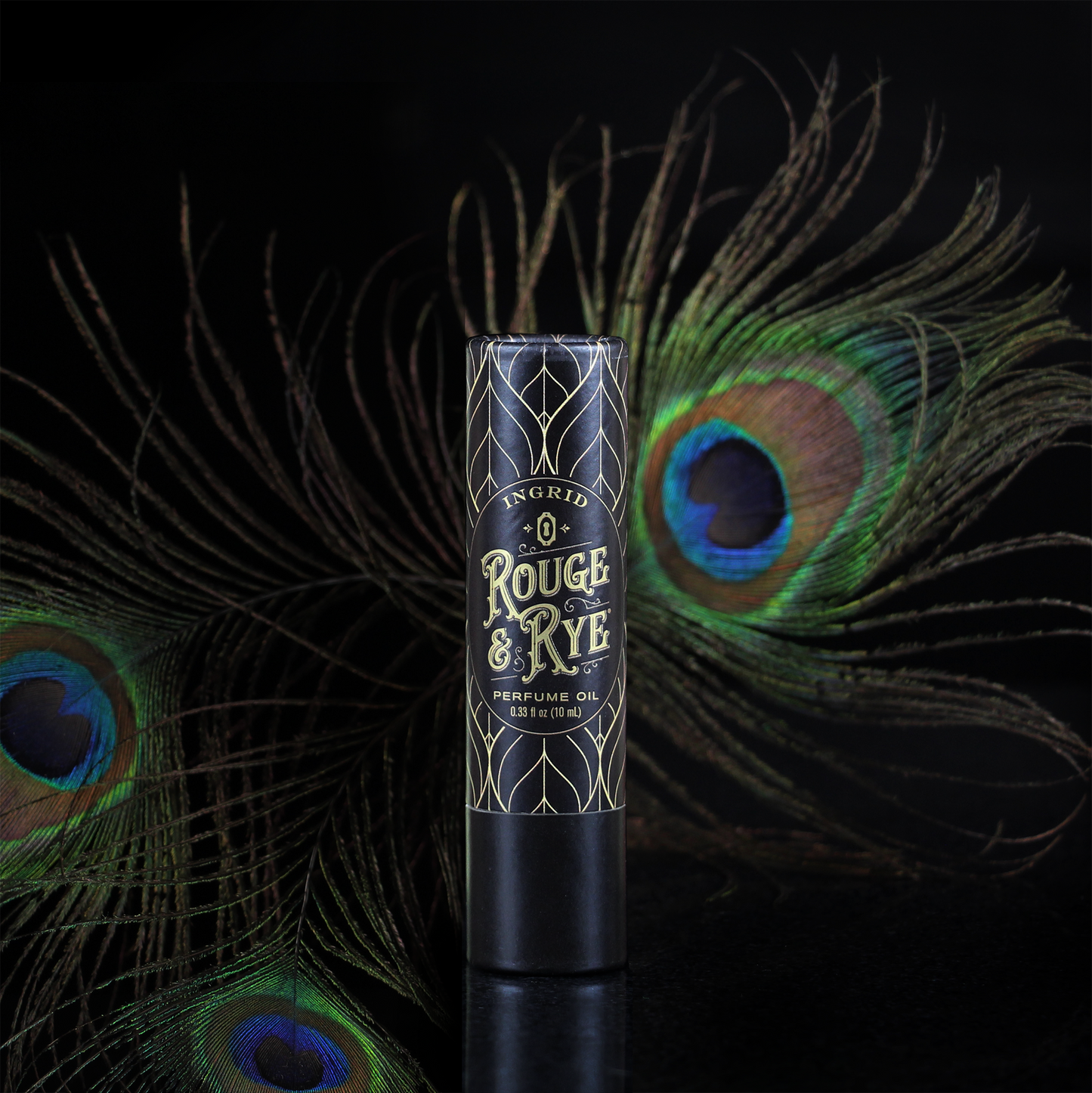 Perfume oil bottle with peacock feathers on a dark background