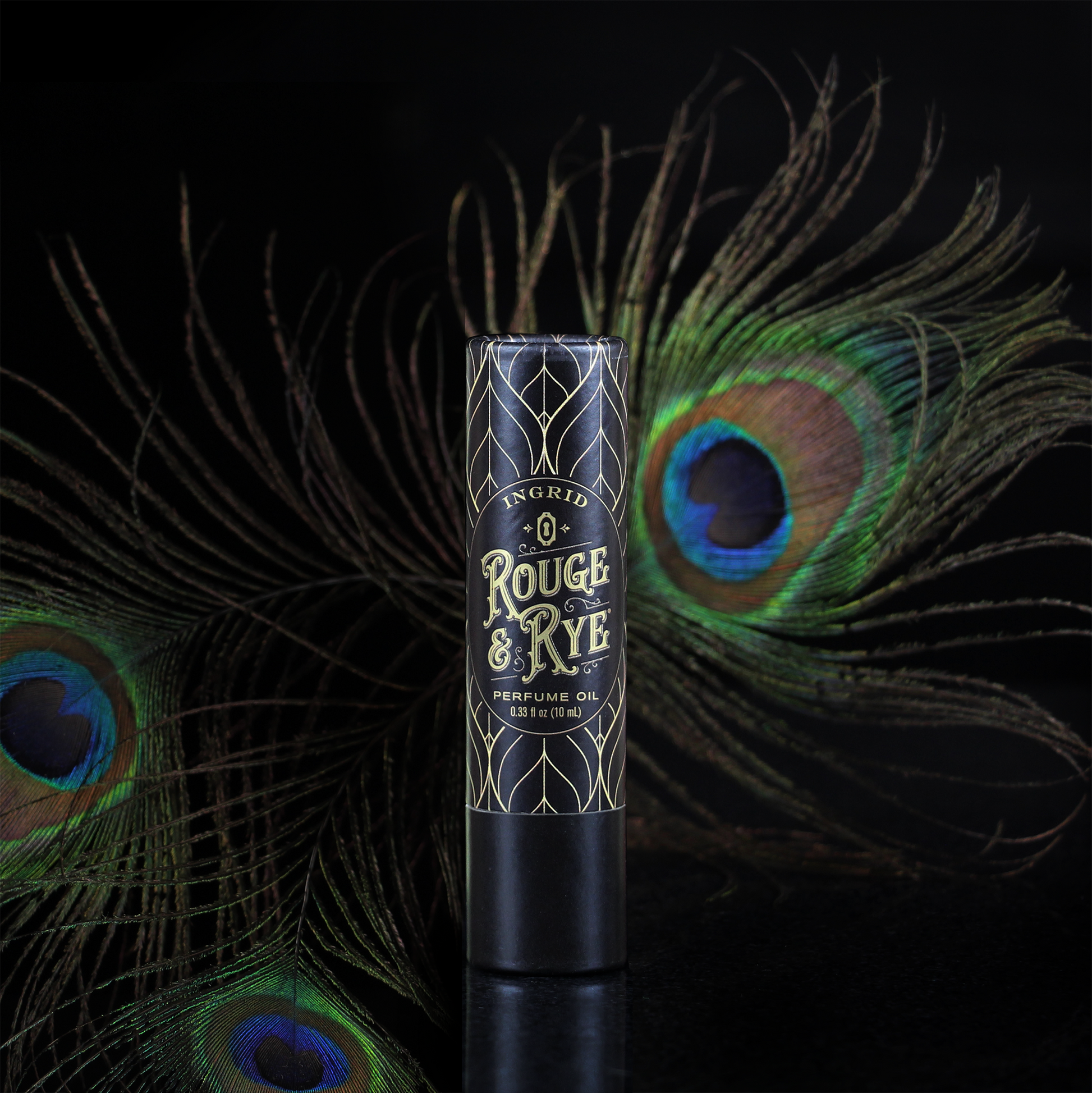 Perfume oil bottle with peacock feathers on a dark background