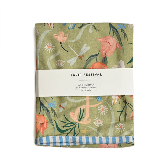 Floral patterned tea towel with 'Tulip Festival' label on a white background