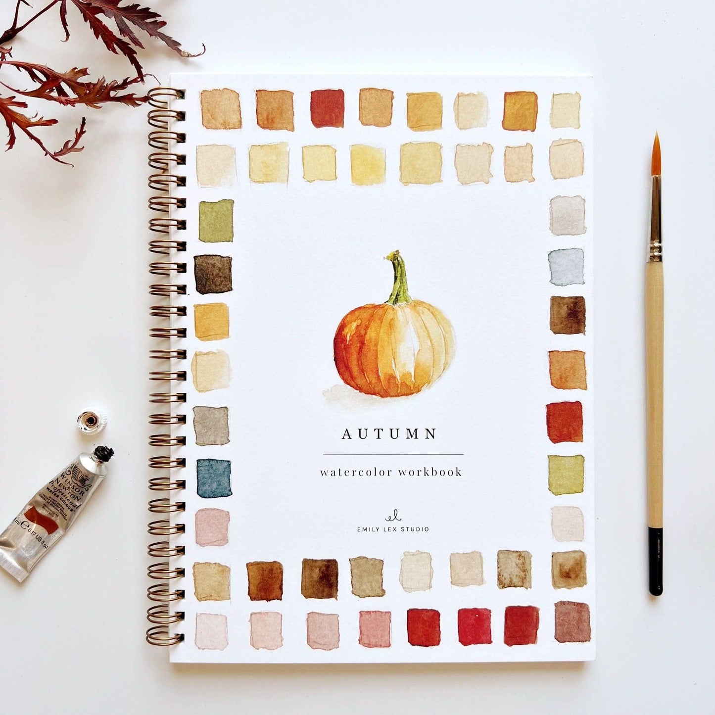 Watercolor workbook with autumn theme on a white background