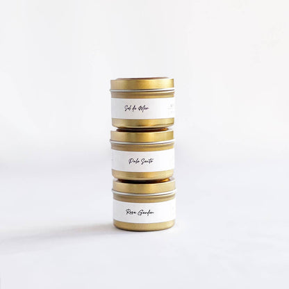 Stack of cylindrical tins with gold accents on a white background