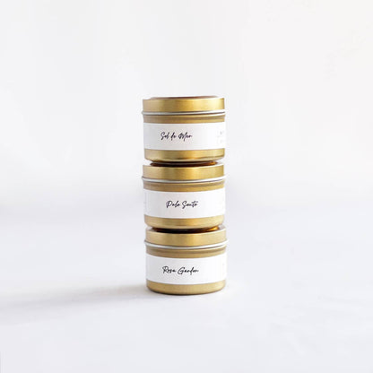 Stack of cylindrical tins with gold accents on a white background