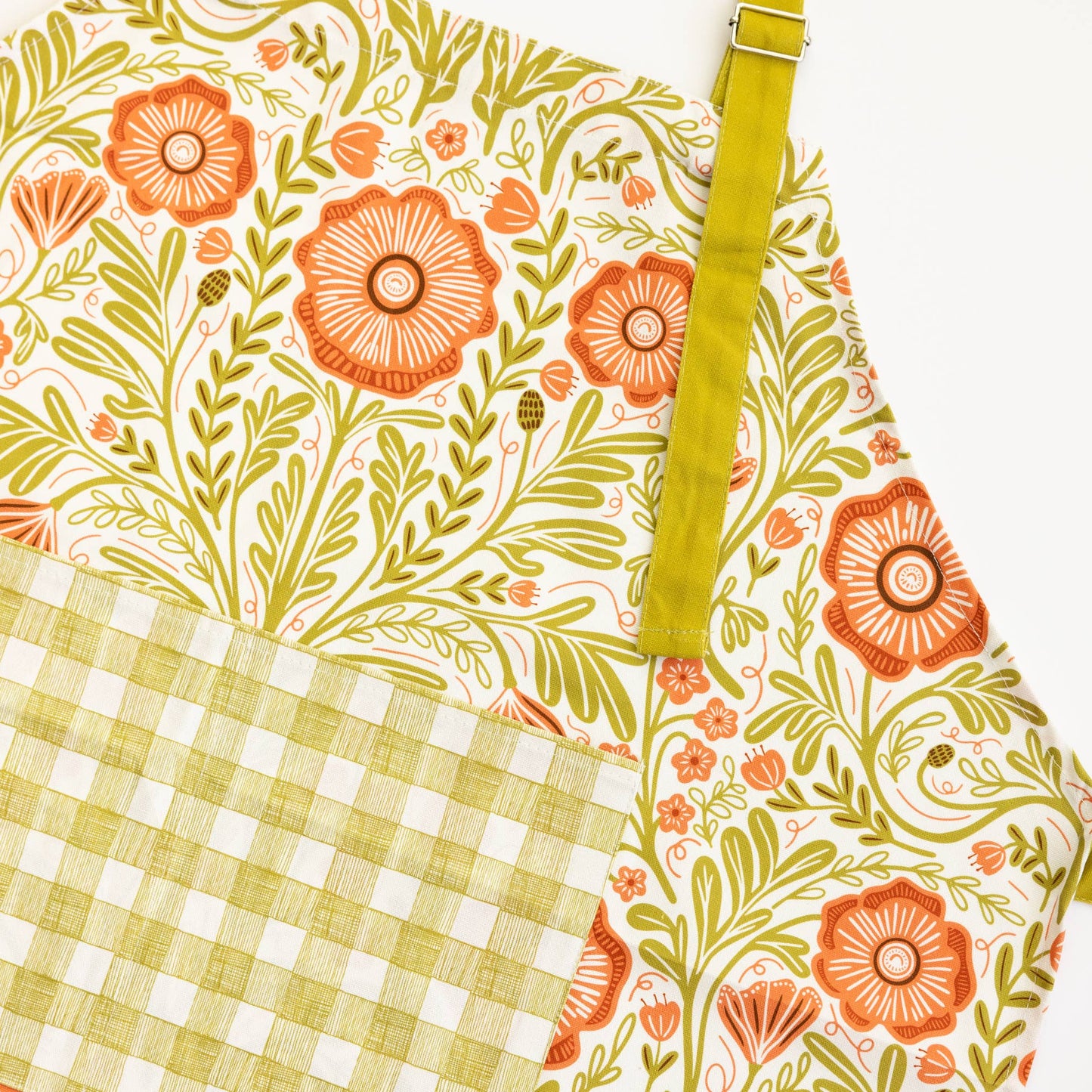 Floral and checkered fabric with a green strap on a white background