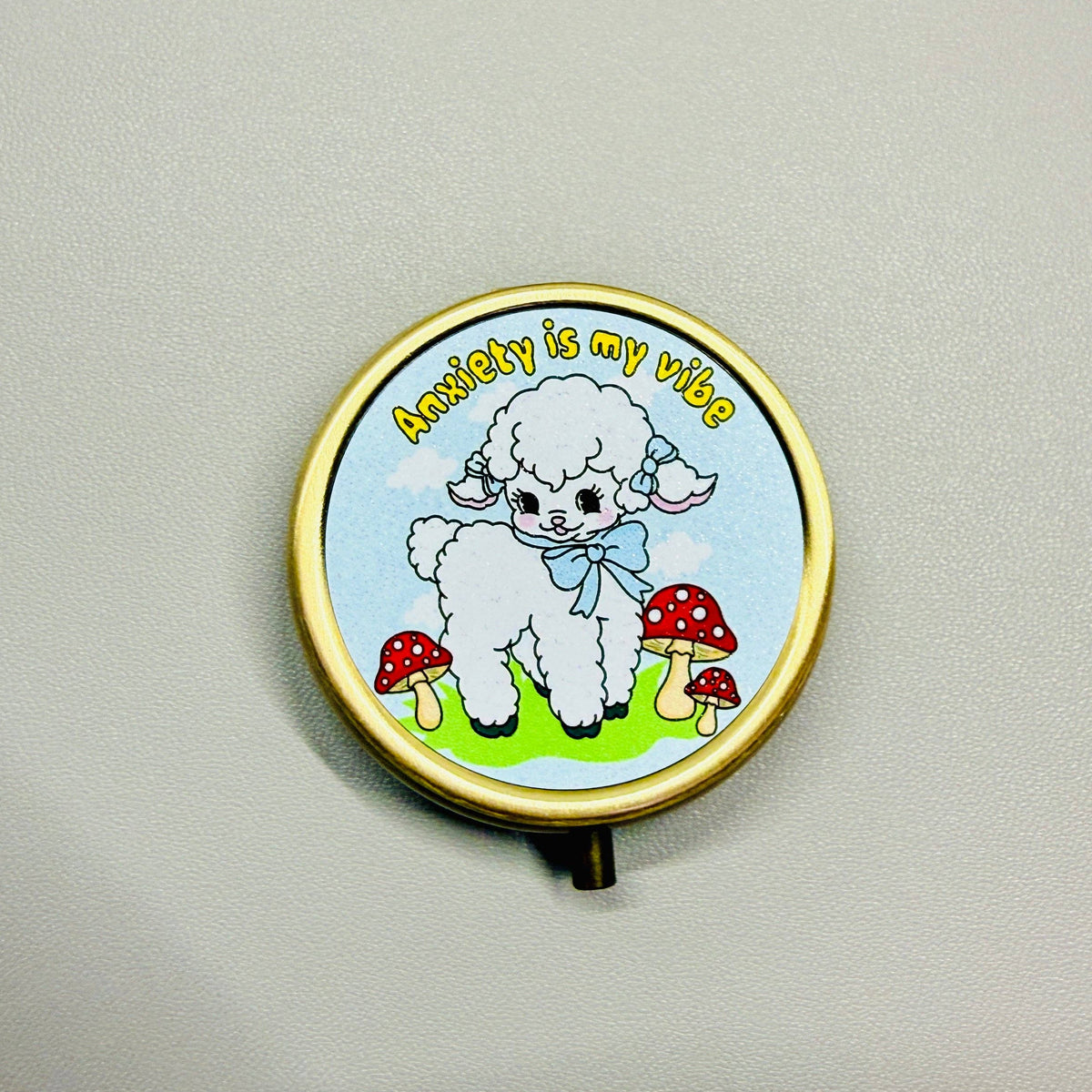 Round decorative item with a cartoon sheep and mushrooms design on a plain background