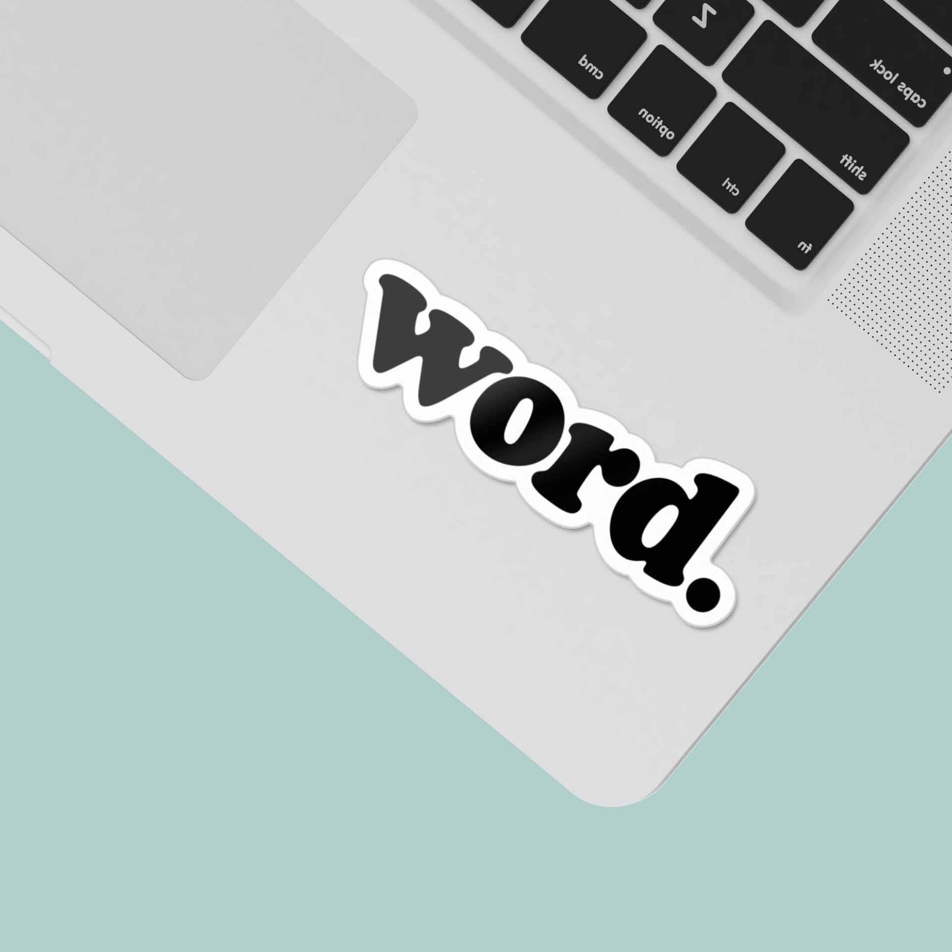 Laptop with a 'word.' sticker on a light green background