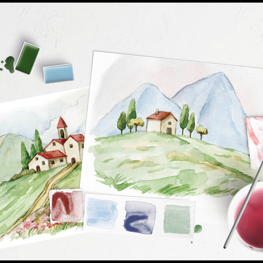 Watercolor landscape painting with mountains and houses, surrounded by paint swatches and a brush.