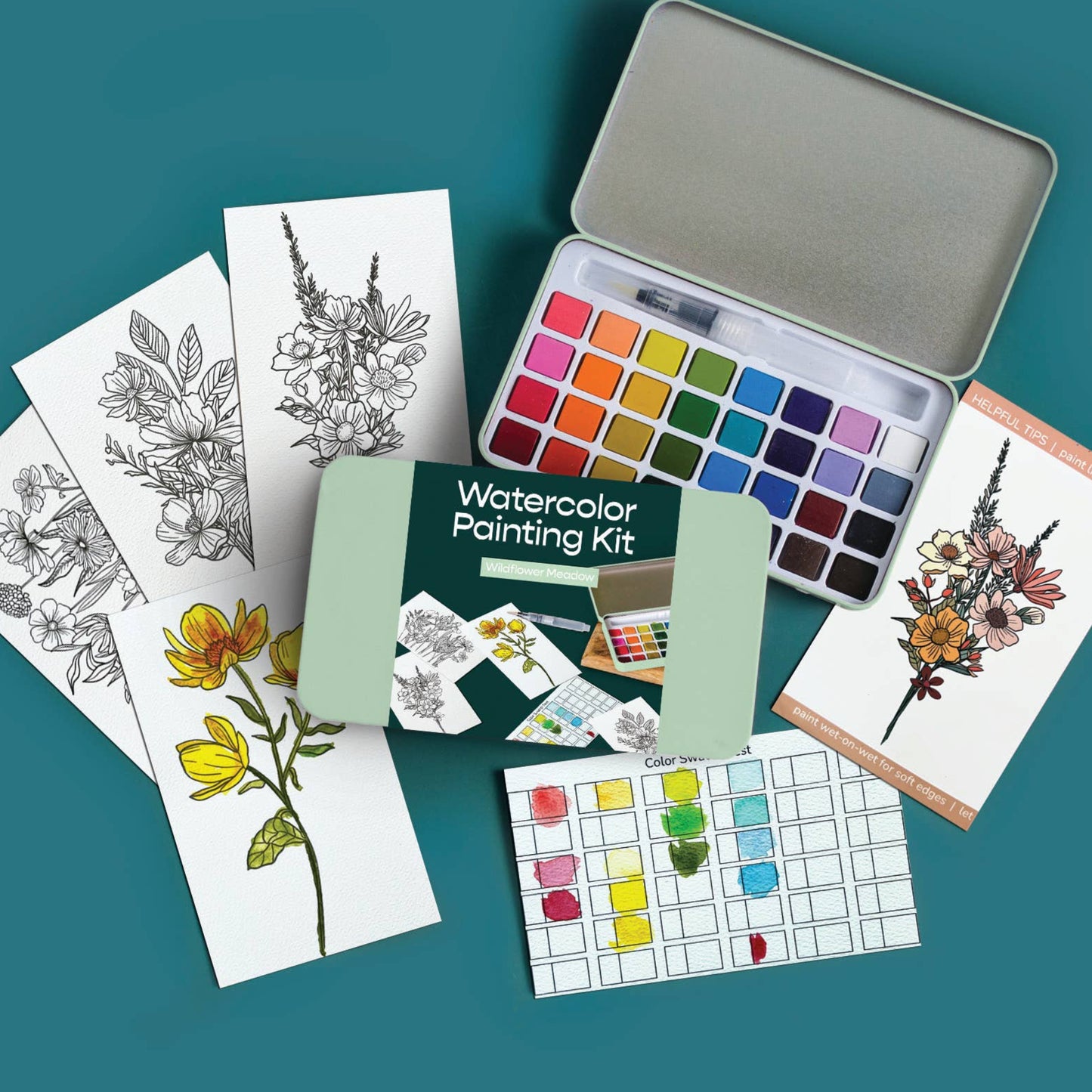 Watercolor painting kit with color swatches and sample cards on a teal background