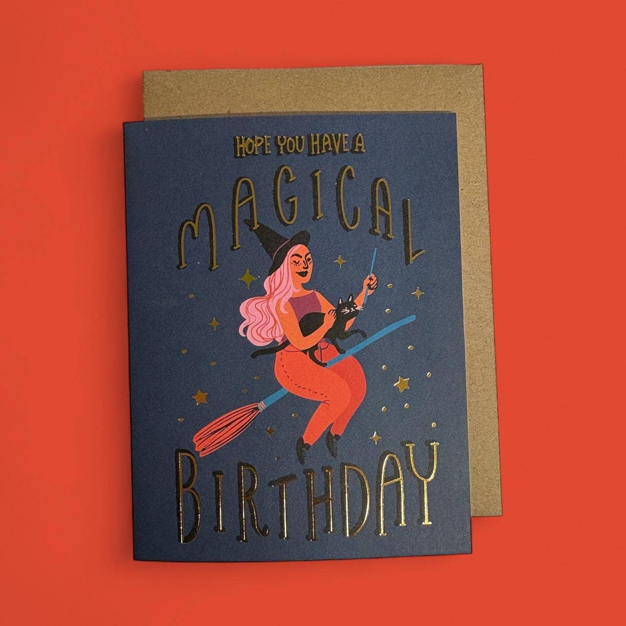 Greeting card with witch illustration and 'Magical Birthday' text on a red background