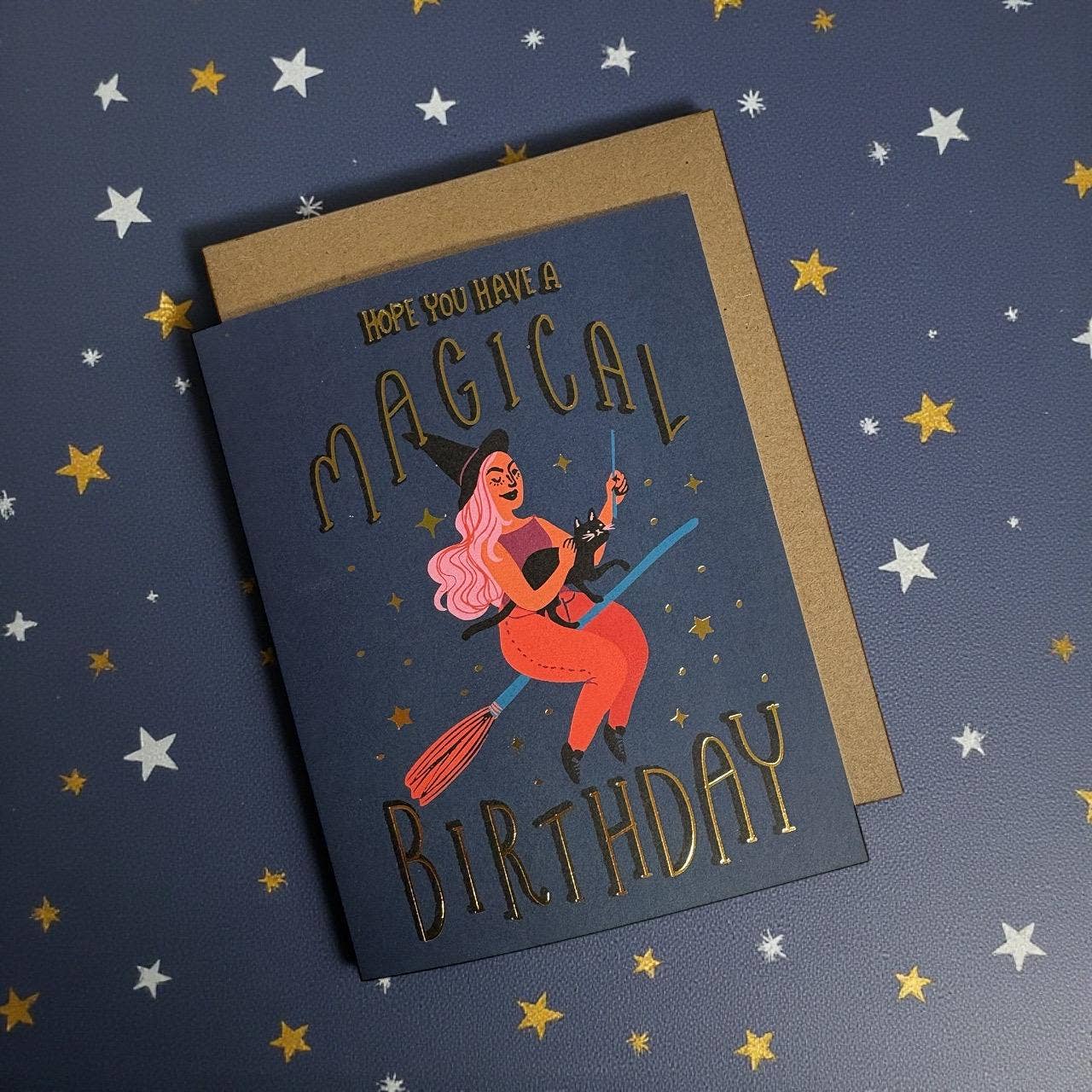 Birthday card with witch illustration and 'Magical Birthday' text on a star-patterned background