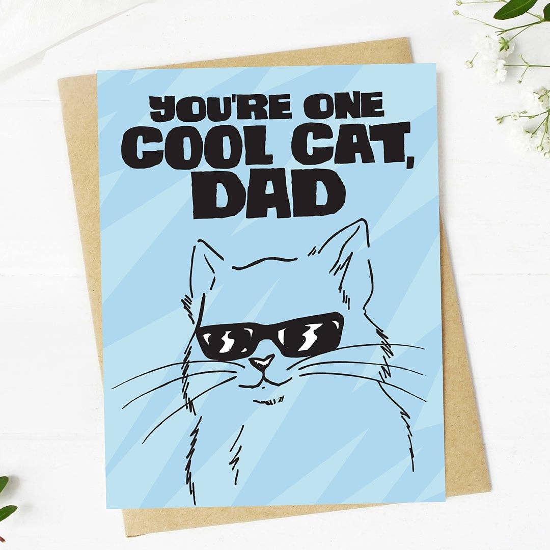 Greeting card with a cat illustration and text 'You're one cool cat, Dad' on a blue background.